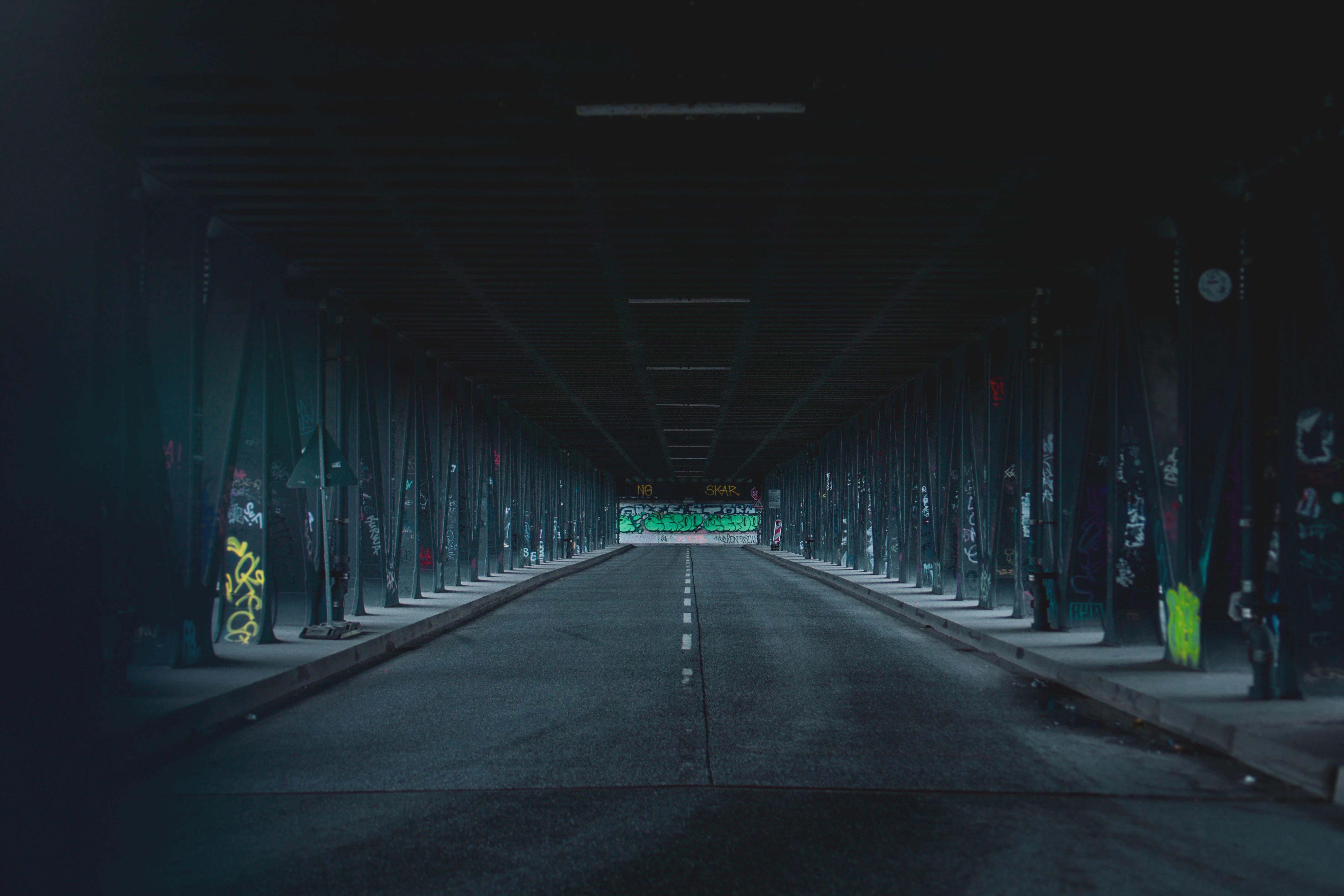 empty tunnel with lights turned on during nighttime
