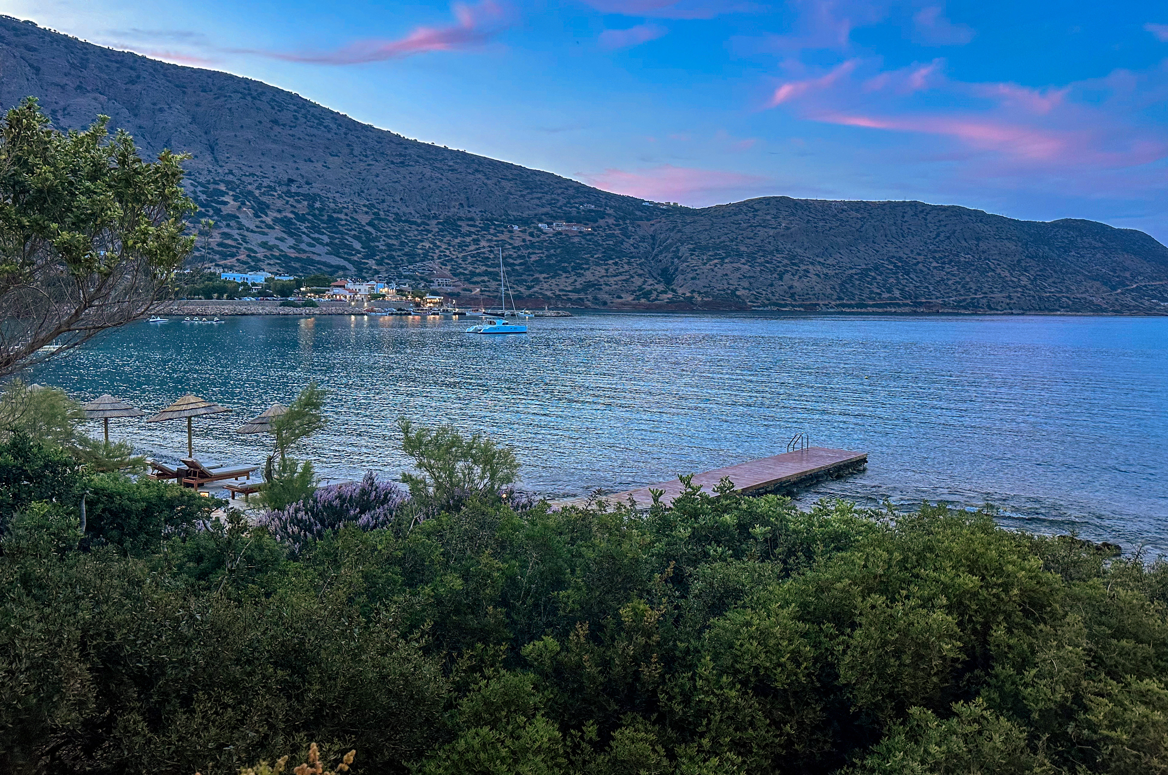 a body of water surrounded by trees and mountains
