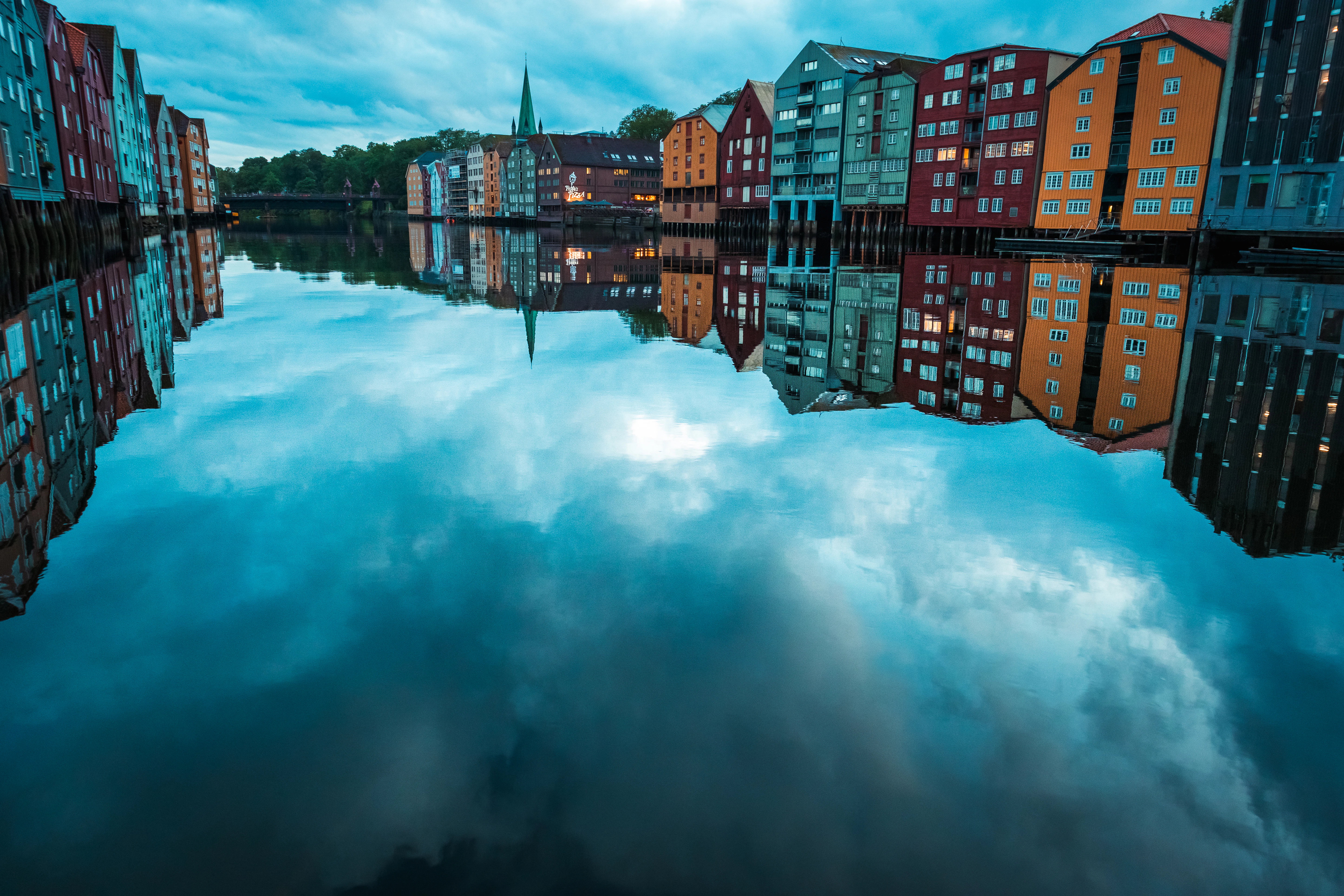 A reflection of buildings in a body of water