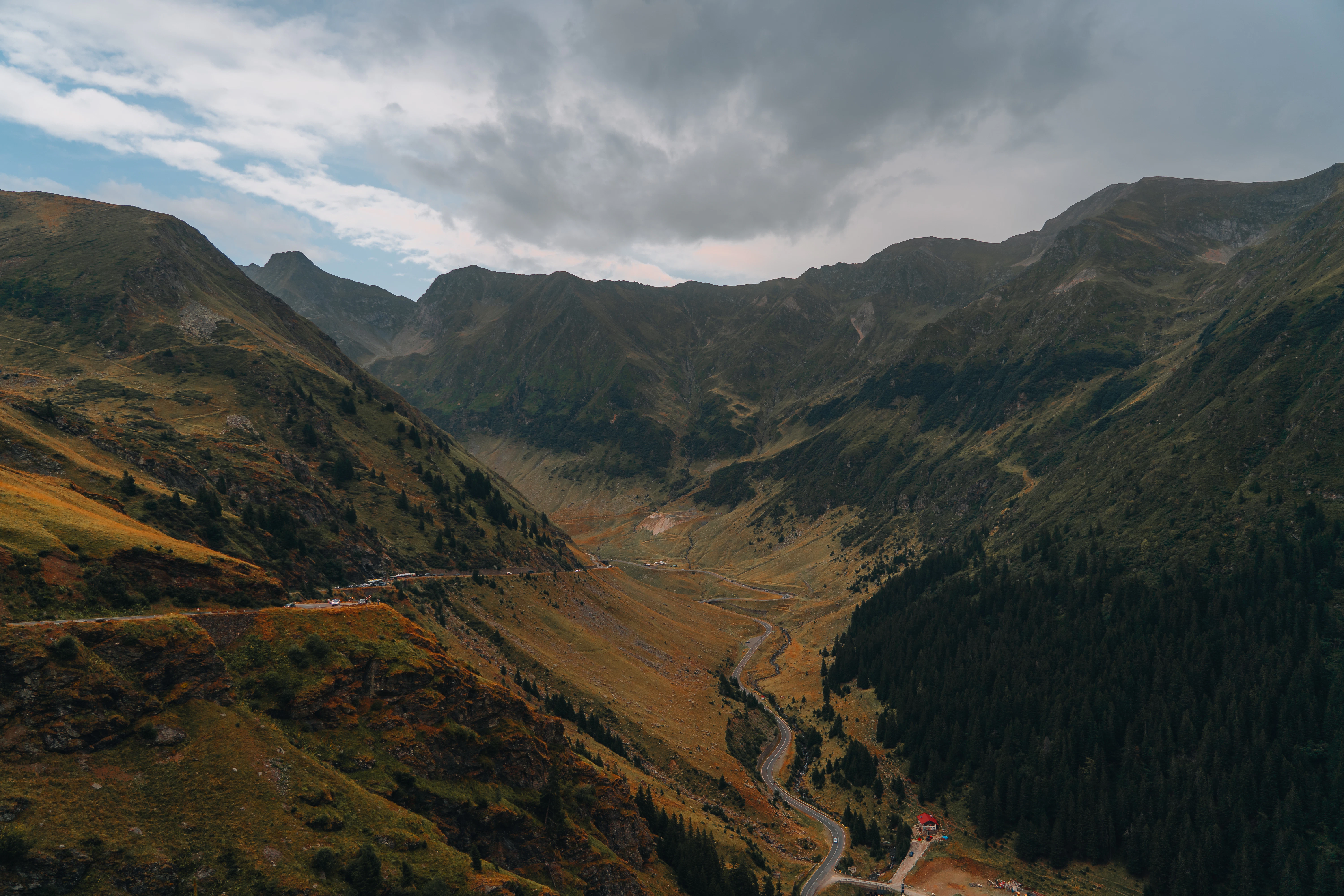 An aerial view of a winding road in the mountains