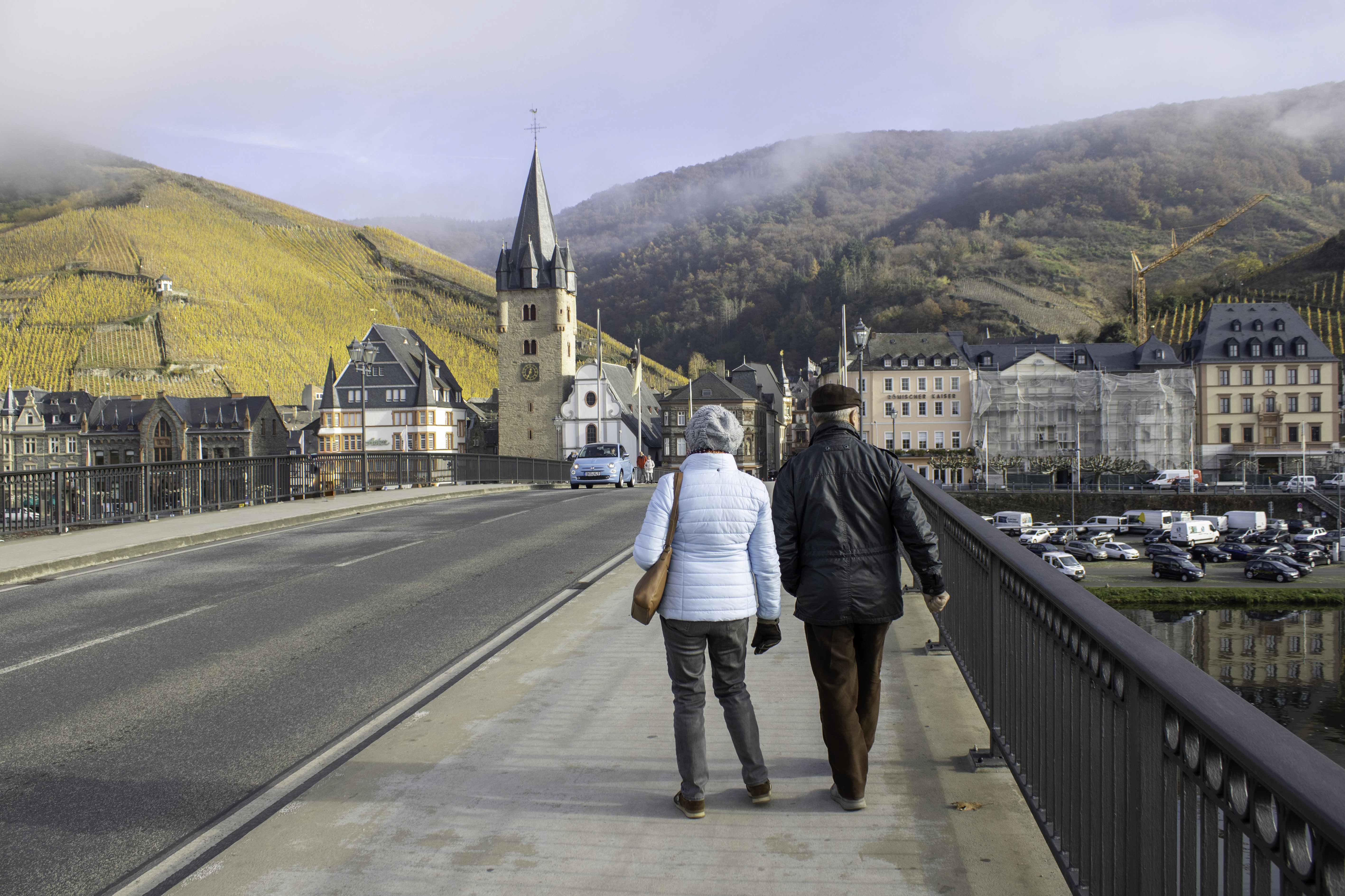 a man and a woman walking on a bridge