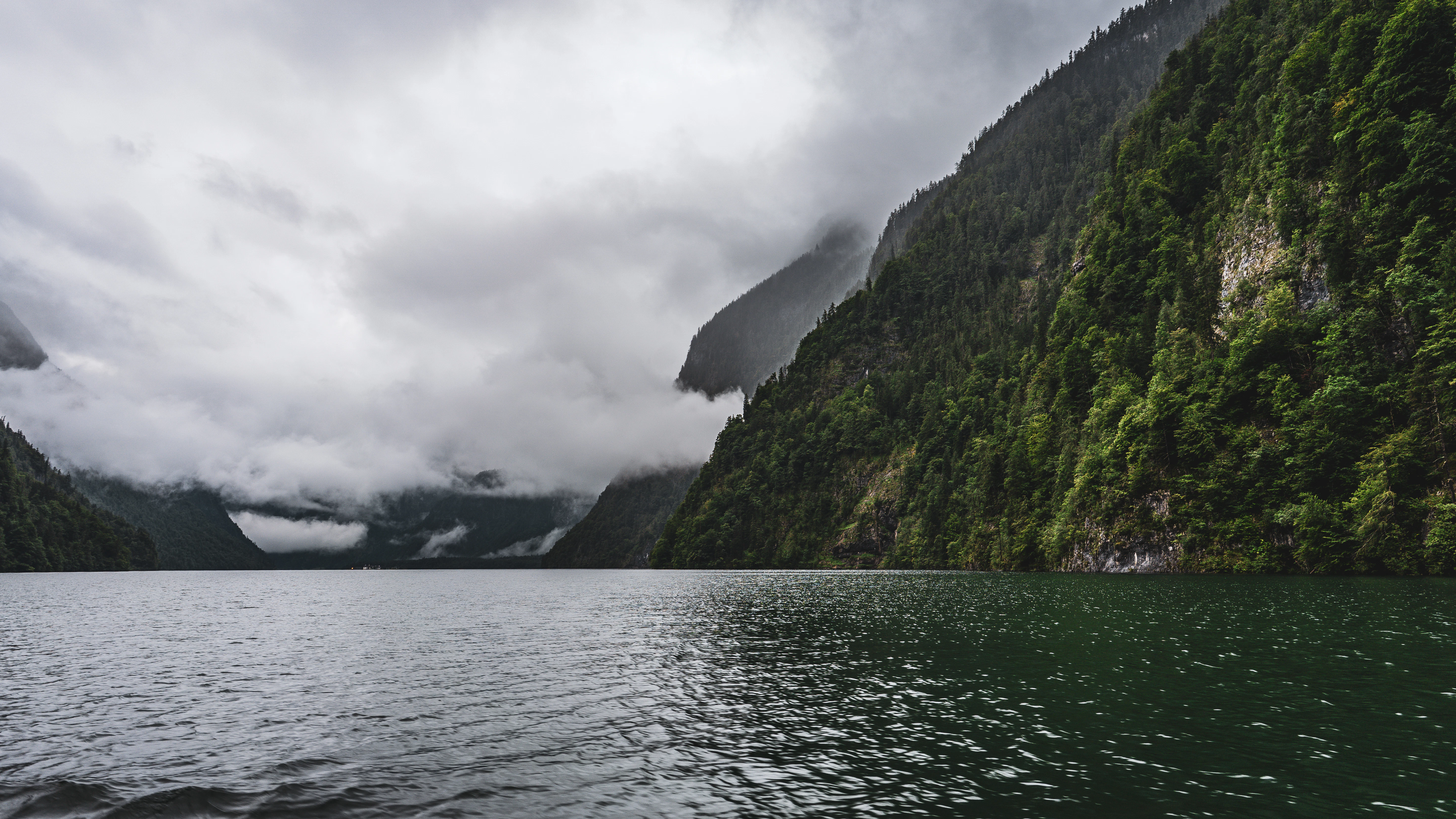 Dramatic mountain landscape with a misty lake view.