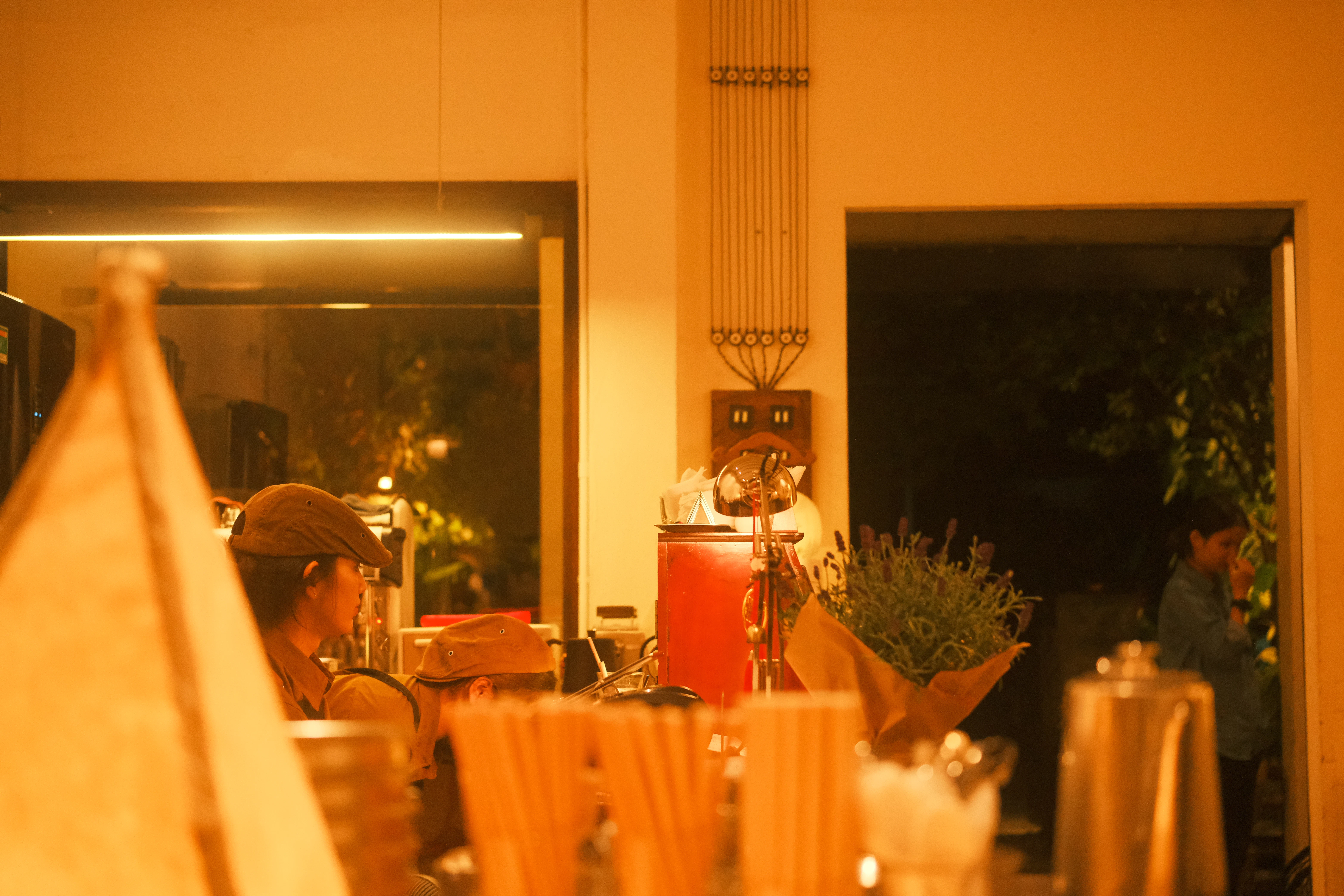People behind a bar with drinks and drinks