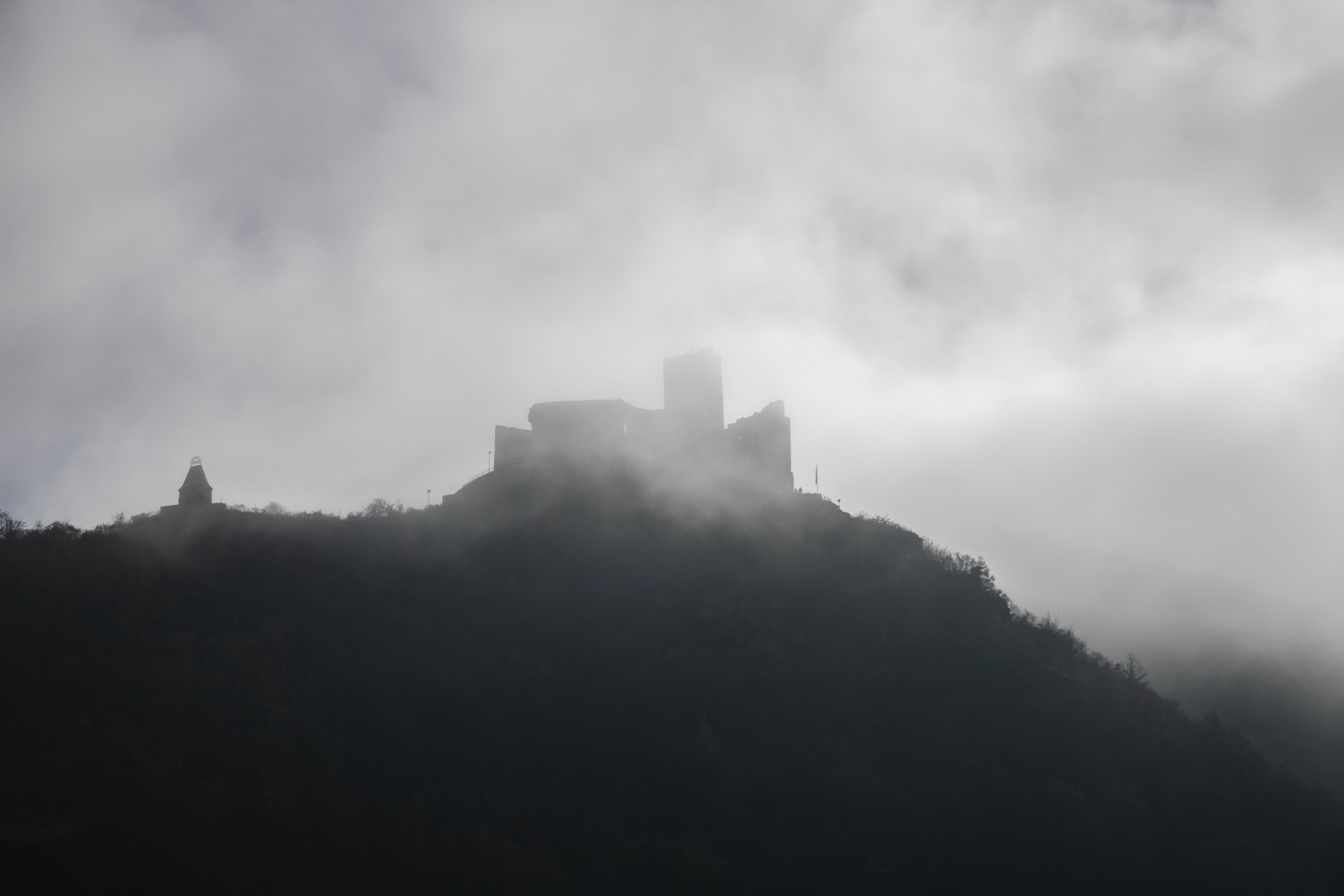 a castle on top of a hill in the fog