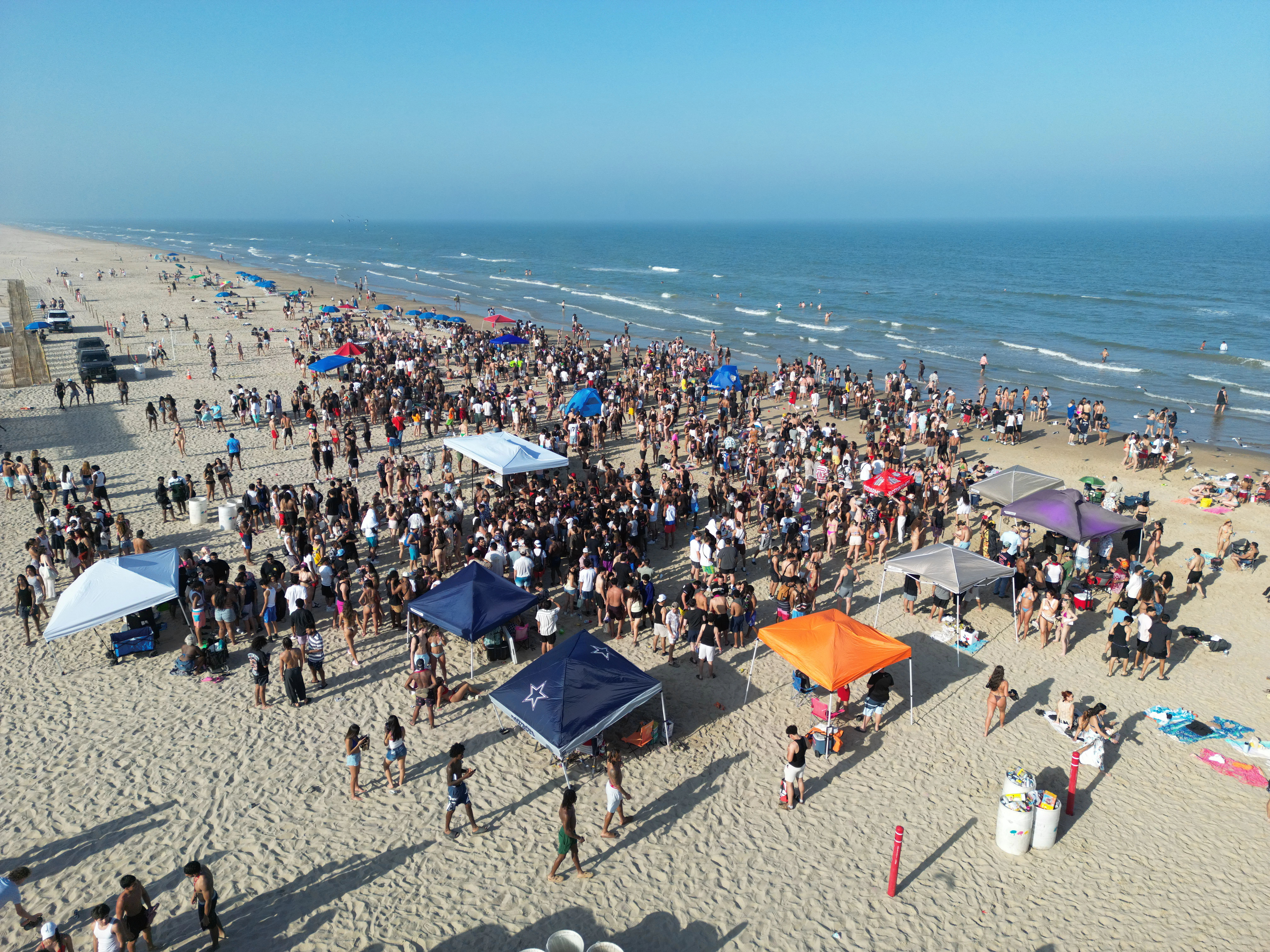 People are gathering on the beach for a party.