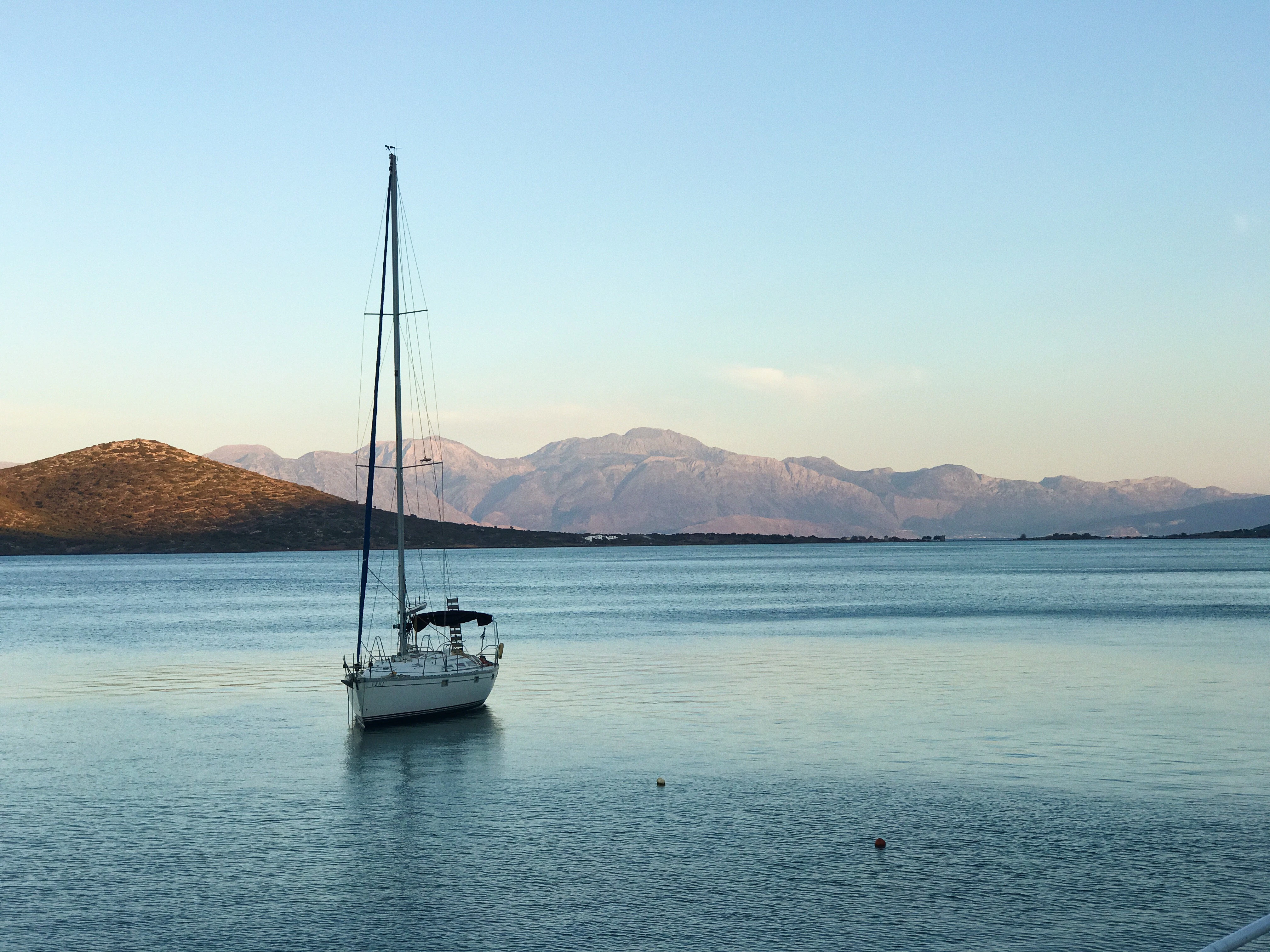 white boat sailing under blue sky during daytime