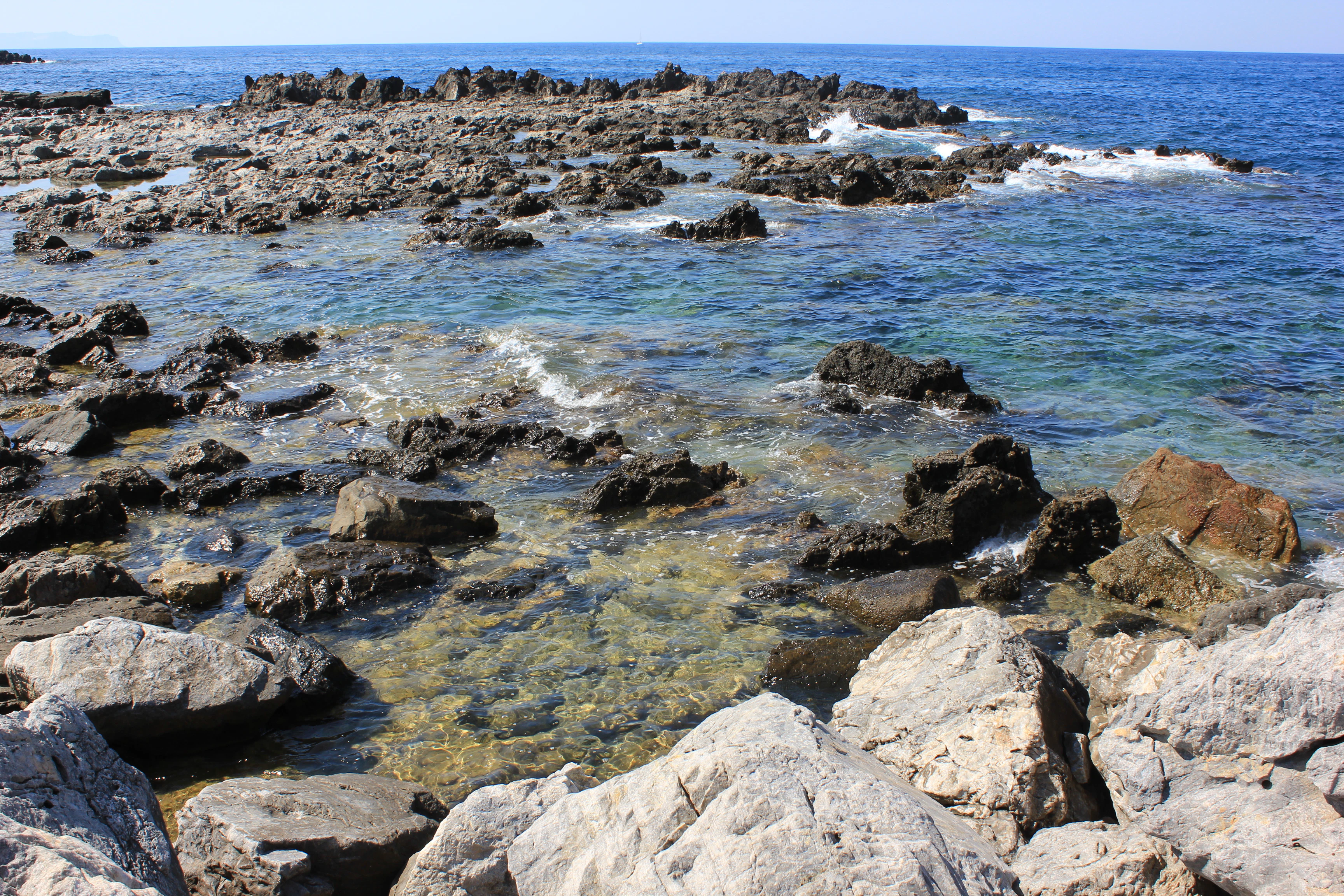 a rocky beach with waves crashing