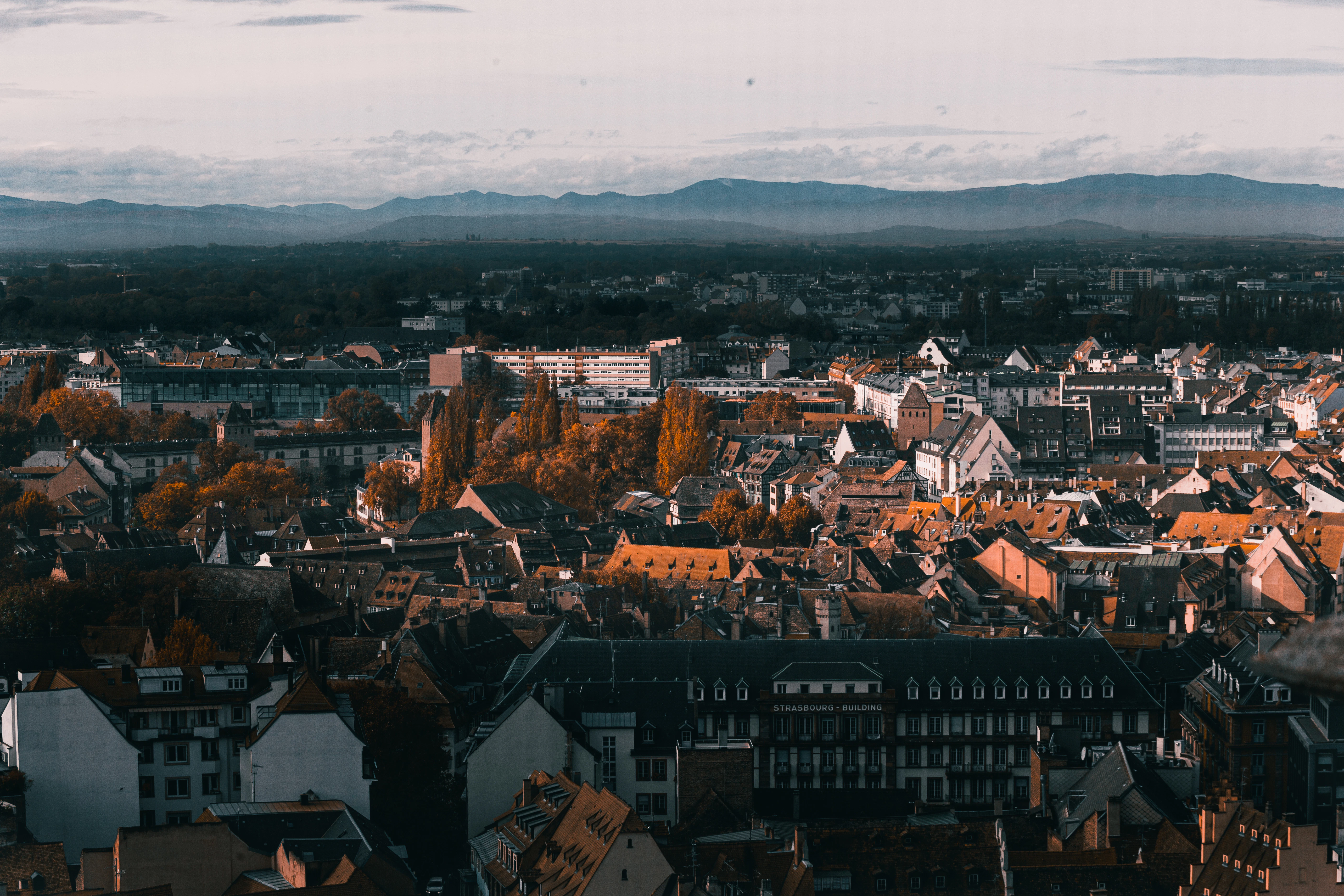 an aerial view of a city with mountains in the background