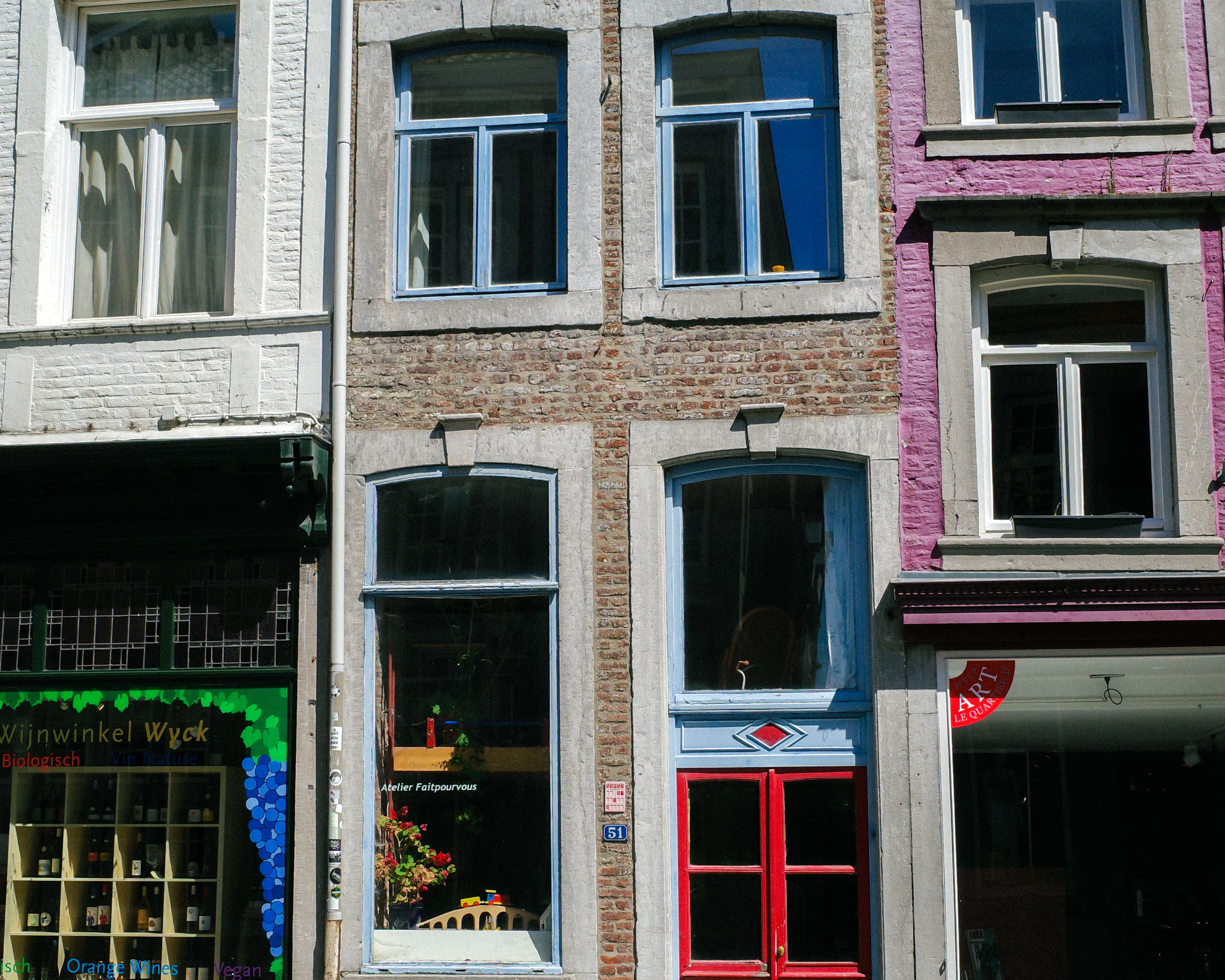 Colorful buildings feature windows in a city setting.
