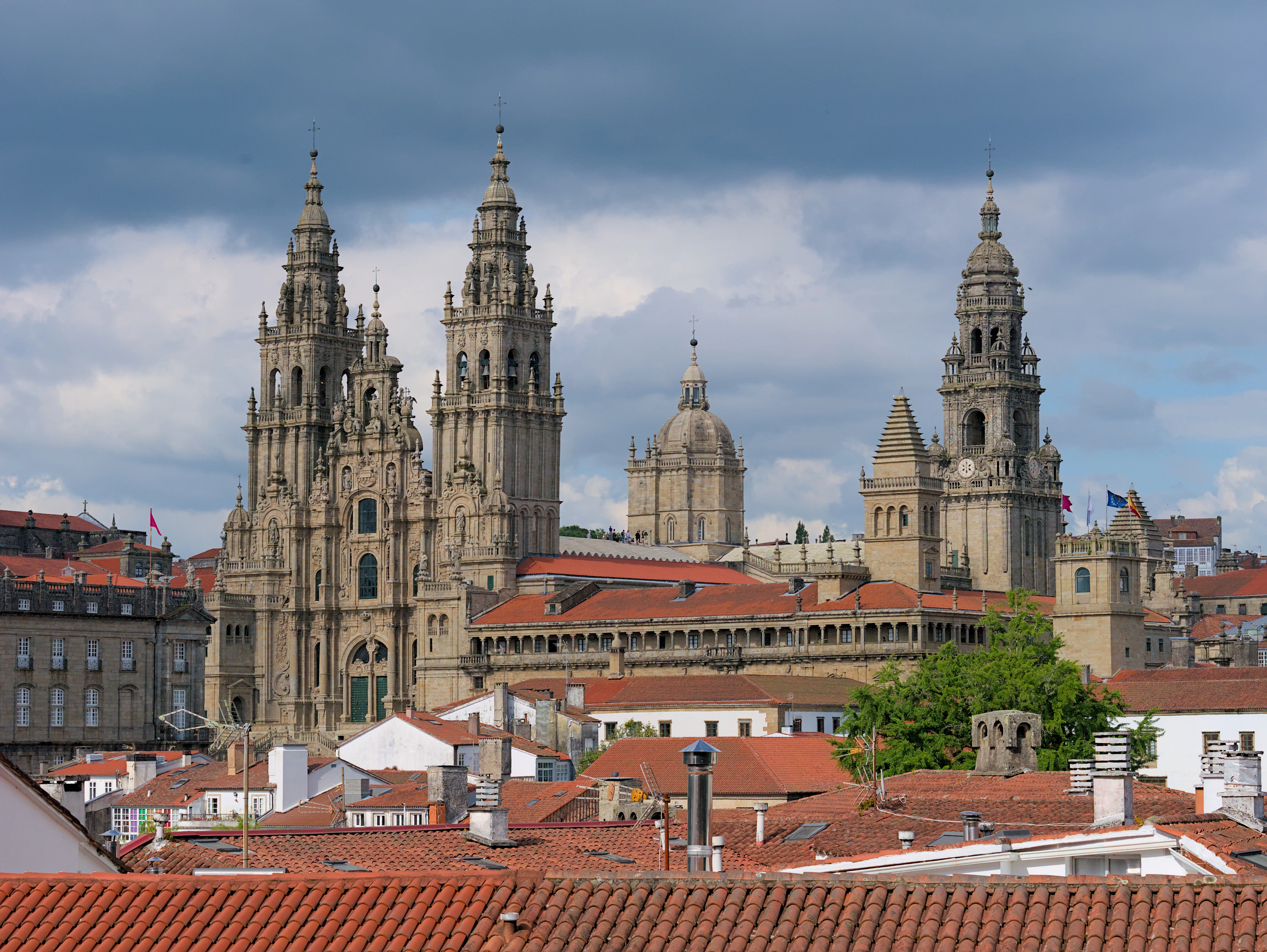 Cathedral towers rise above rooftops in a city.