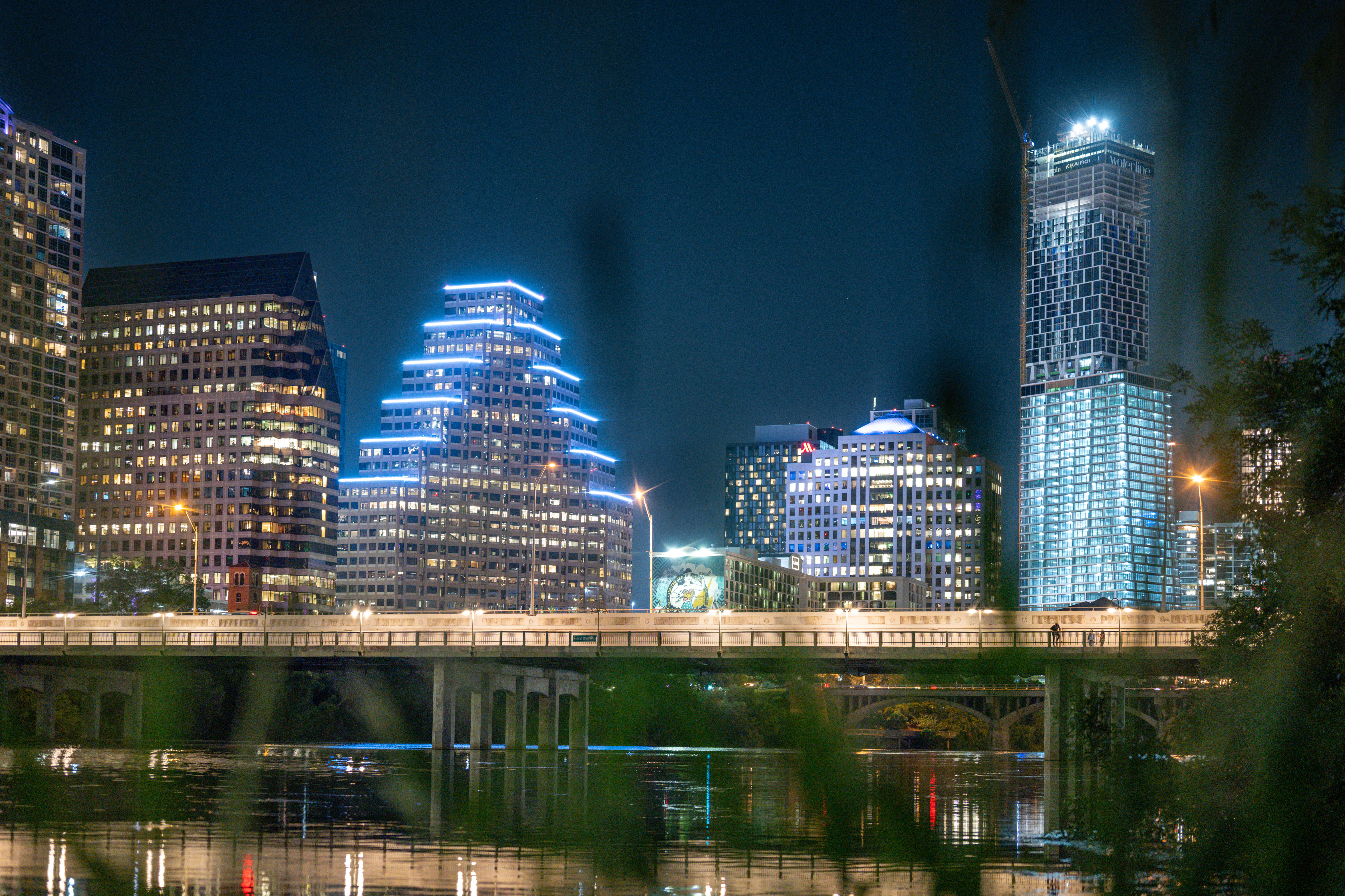 Bright cityscape with illuminated buildings at night.