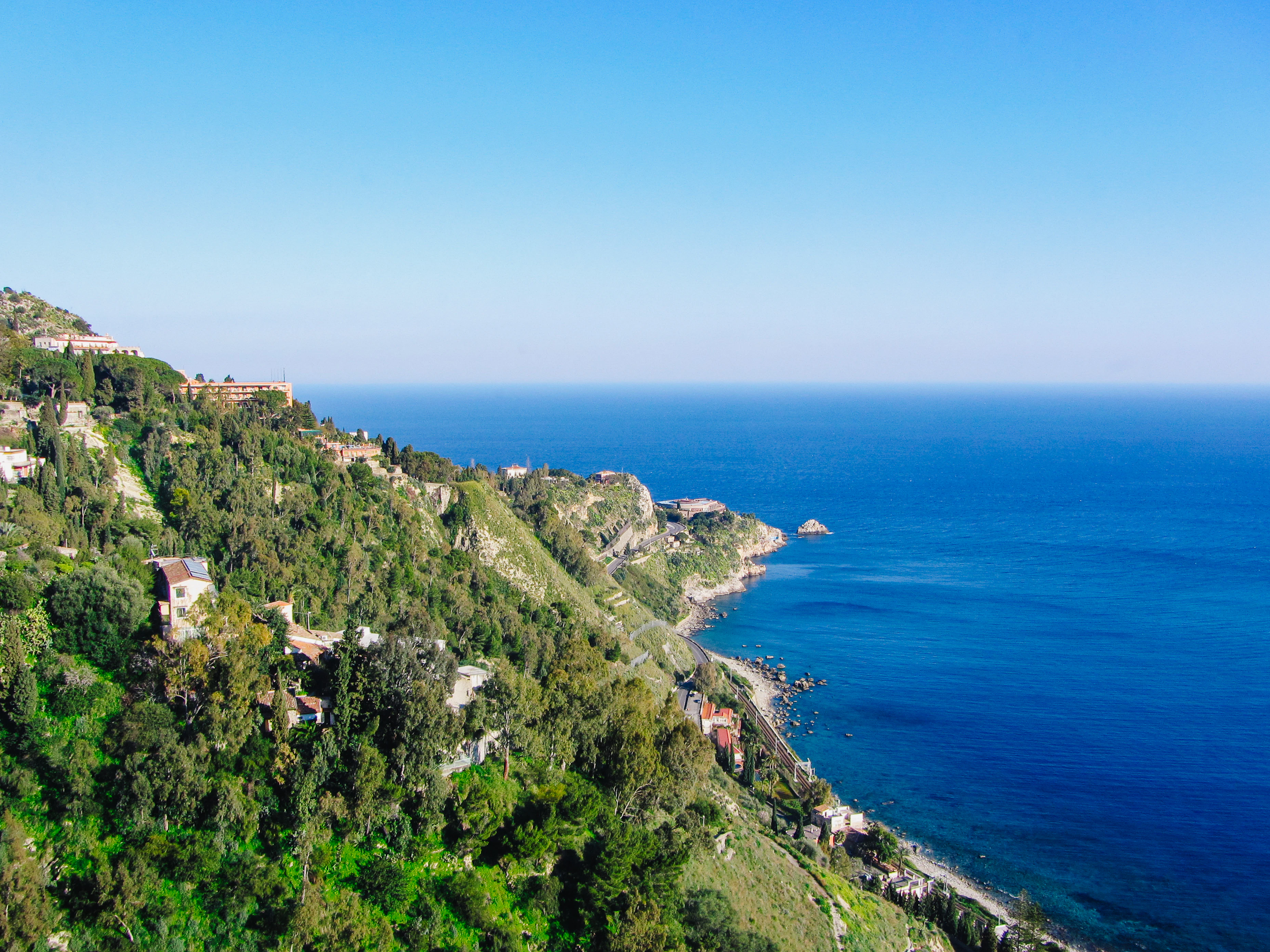 a scenic view of the ocean from a hill