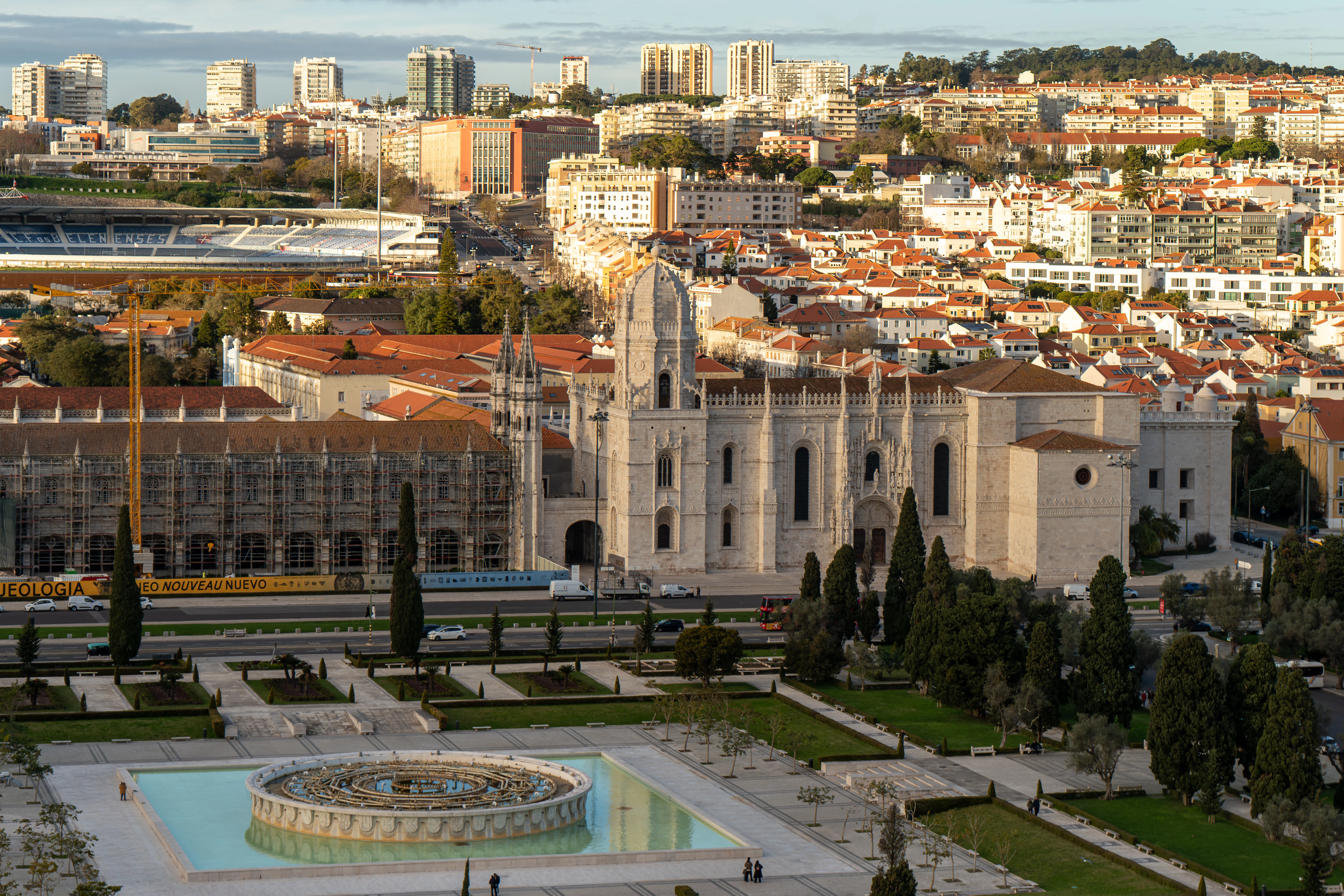 Historic monastery with city skyline and garden