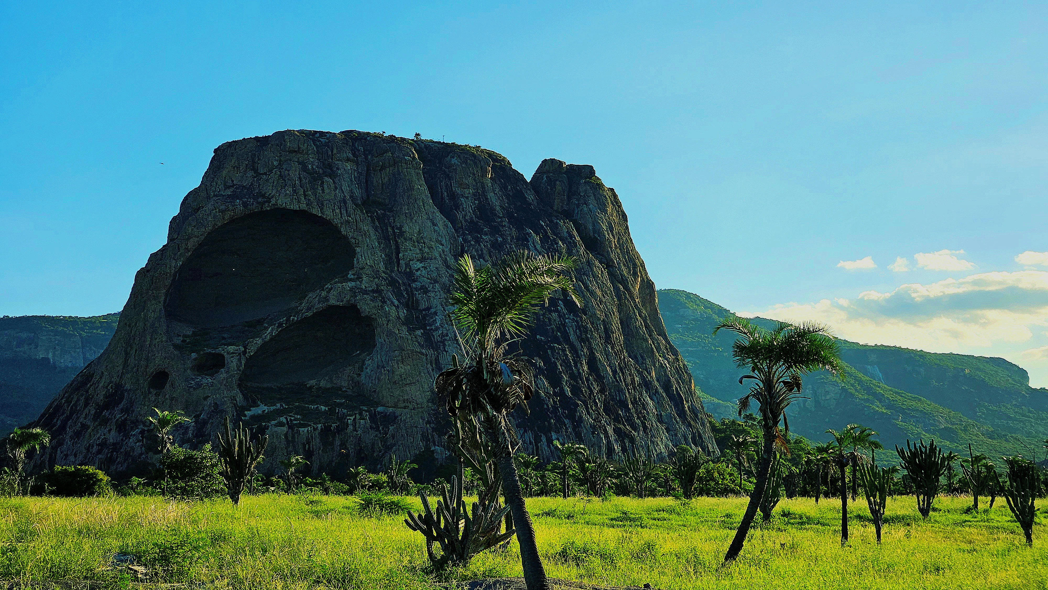 a large rock formation in the middle of a field