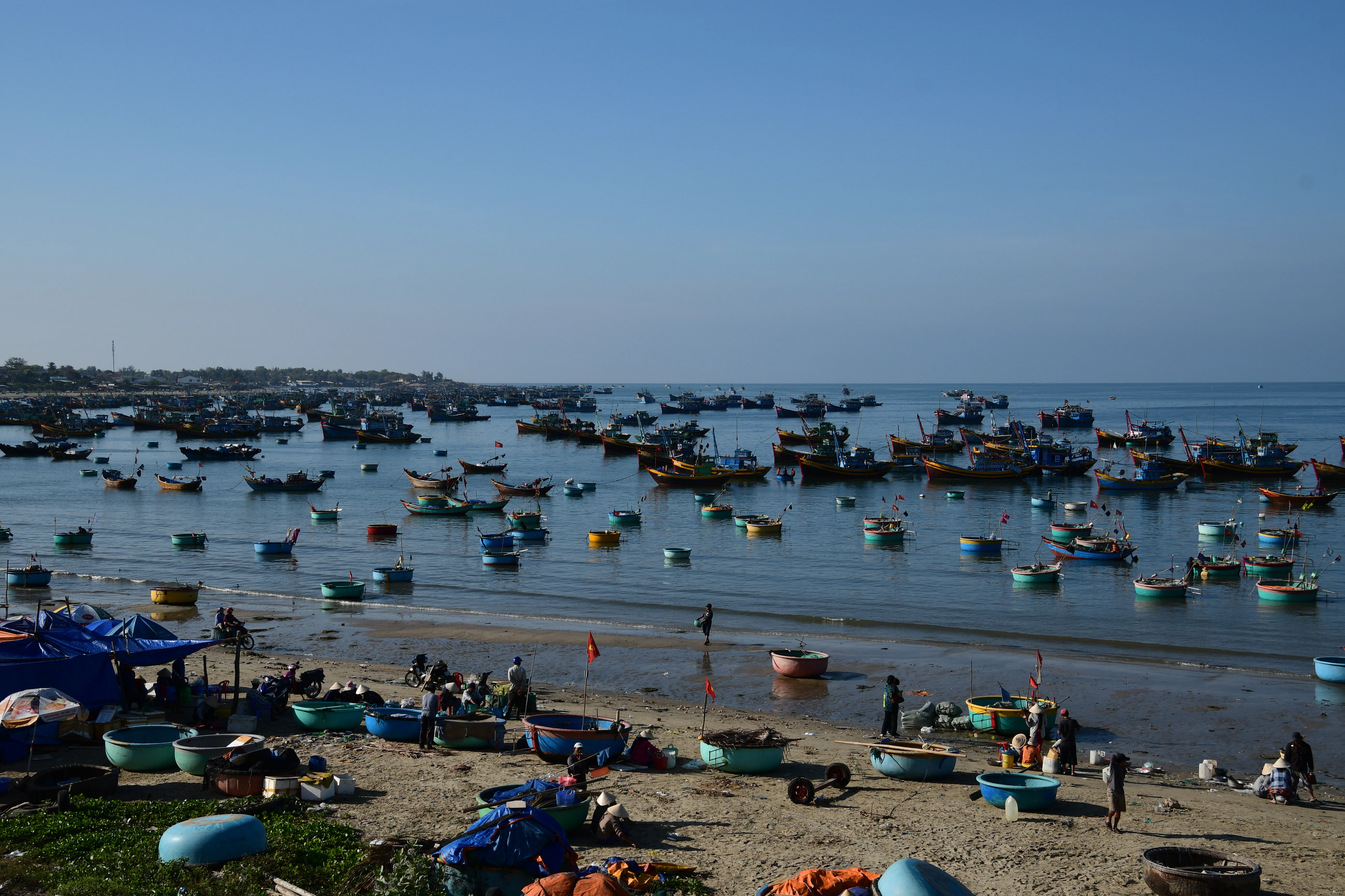 a group of boats floating on top of a body of water